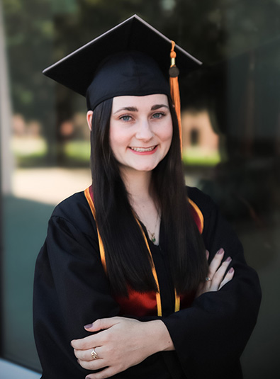 Photo of Abigail Hurst in her commencement cap and gown.