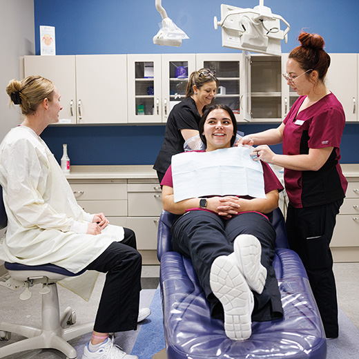 Dental Hygiene students work together in the Gaines Hygiene clinic while under observation.