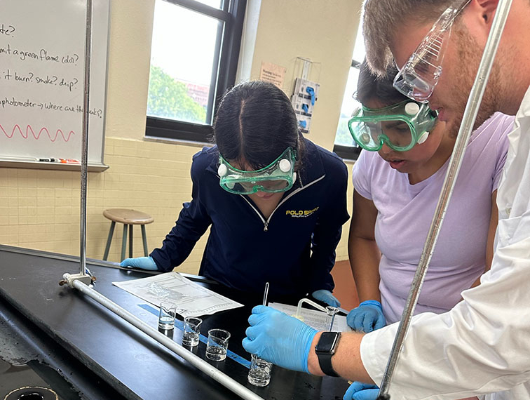 Students working together in a lab during the American Chemical Society road to college event.