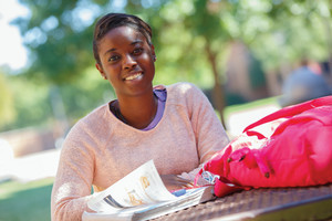 Student outdoors smiling