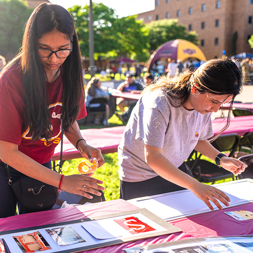 Two students work together on a lettering paper craft during the pre-flight festival on the MSU Texas campus.