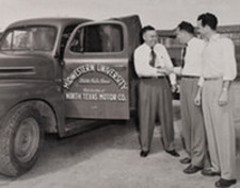 Black and white photo of MSU students with a pickup truck