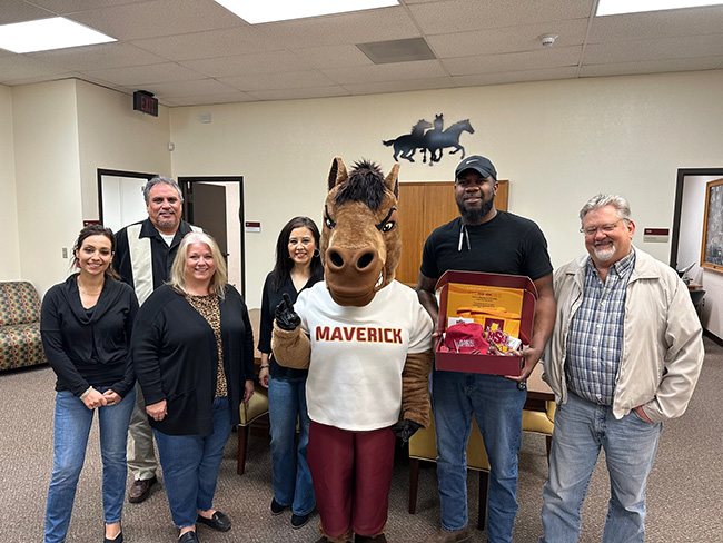 Maverick the Mustang posing with the Purchasing and Contract Management staff, March 3, 2023