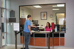 Student standing in front of a service window