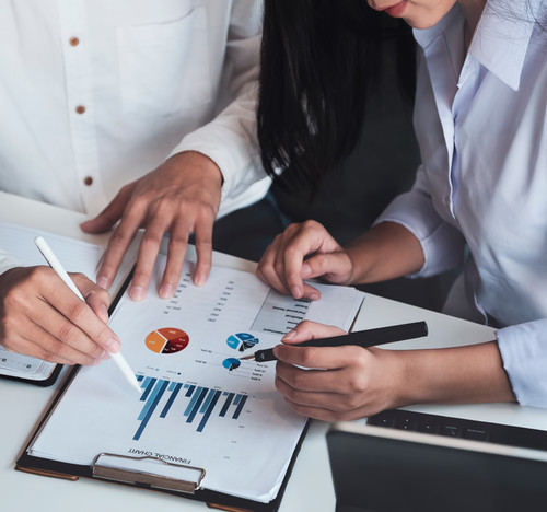 Man and woman looking at business report