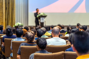 A speaker in front of a corwd