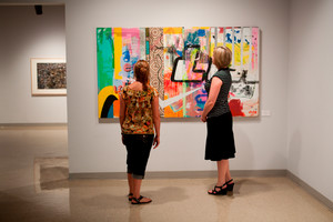 Two women looking at a painting