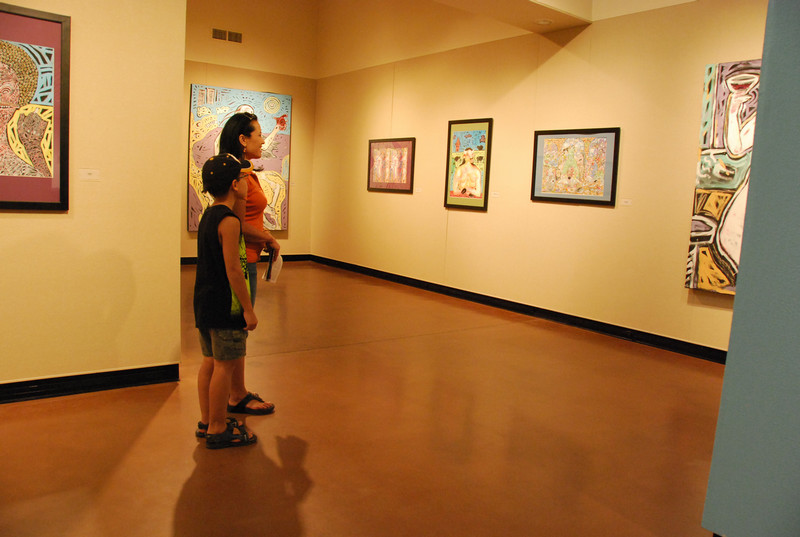 Two people looking at art in a gallery
