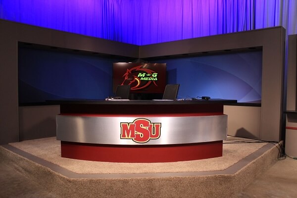 Inside the broadcast studio, showing the anchor desk setup, downstairs in the Mass Communication building.