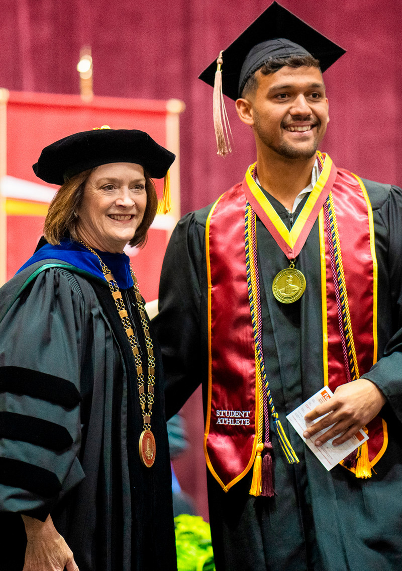 MSU President with grad at graduation