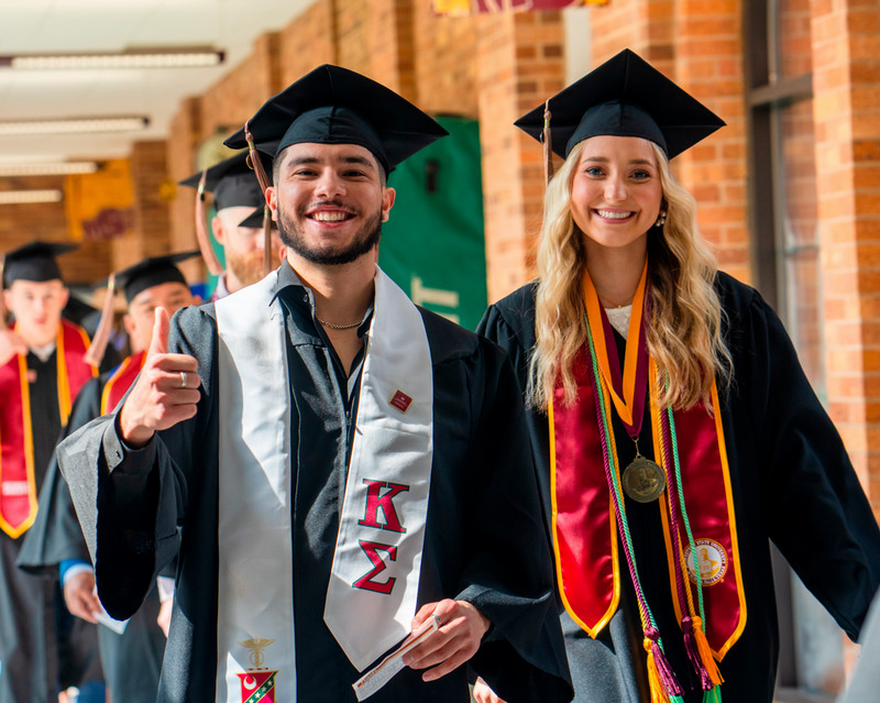 Two students entering graduation
