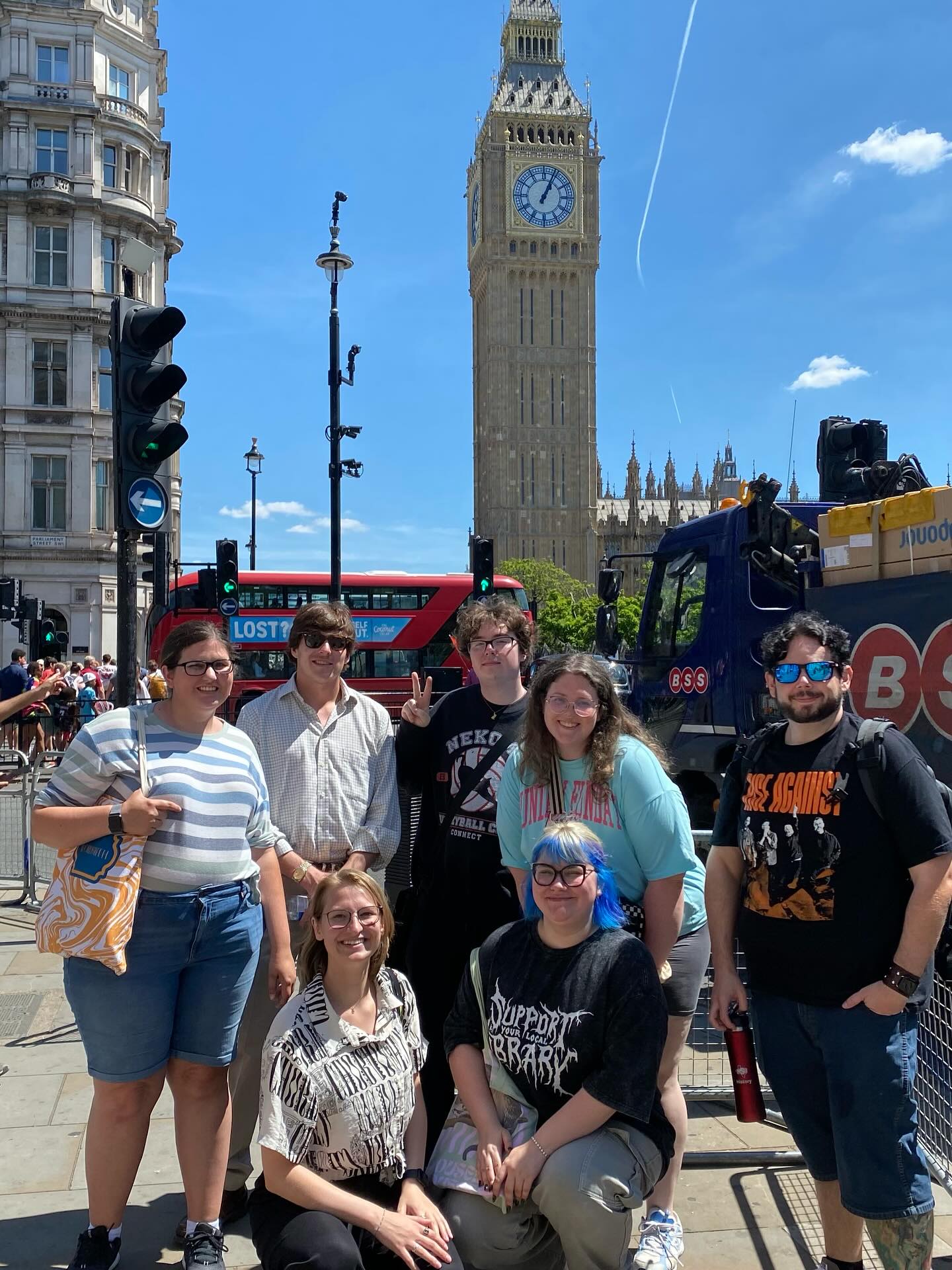 Students in front of a double decker bus in London. 