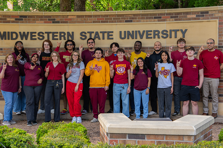 Team Selene members happily pose near the Midwestern State University welcome sign.