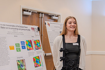 A Geosciences student presents her research with a poster presentation during EURECA.