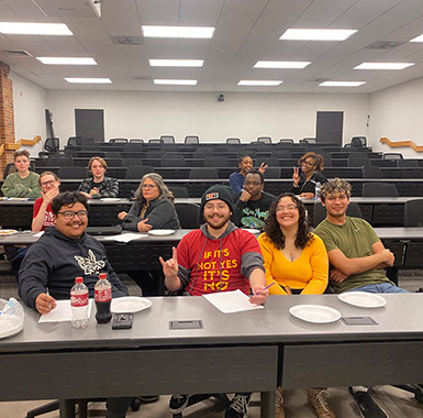 A group of students happily pose during Math Club's Pizza and Problems event.