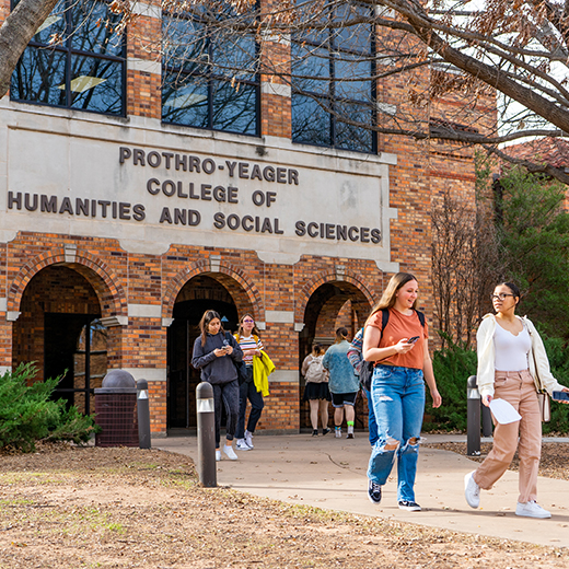 Students walking outside, near Prothro-Yeager College of Humanities and Social Sciences building on the MSU Texas campus.