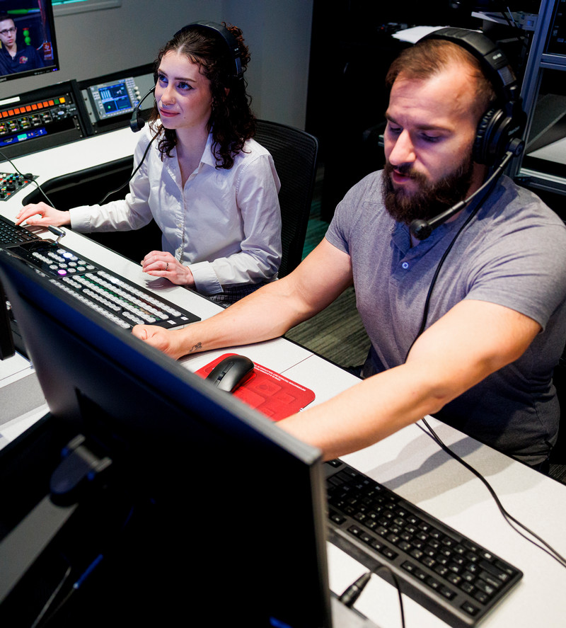 Two mass comm students in a tv studio