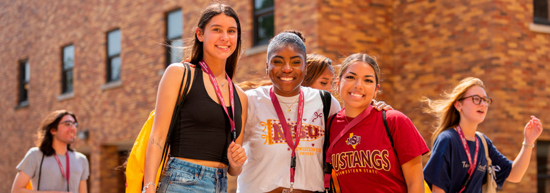 Three students smiling
