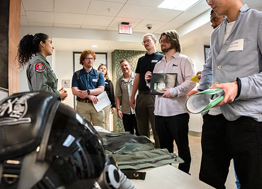  Several students converse with a pilot who attended the Career Fair hosted by the Career Management Center.