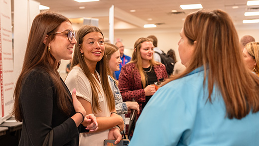 Students and potential employers converse at the Career Fair hosted by the Career Management Center.