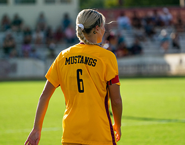 An MSU Texas women's soccer player stands on the soccer field during a game.