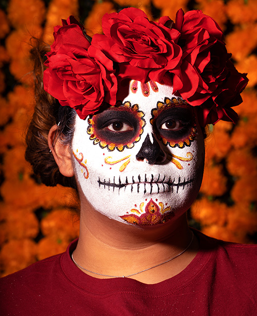 A student proudly displays her face painted for Día de los Muertos during Hispanic Heritage Month.