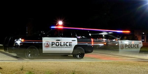 Police Car at night driving on msu