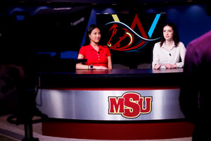 Two students anchoring the news