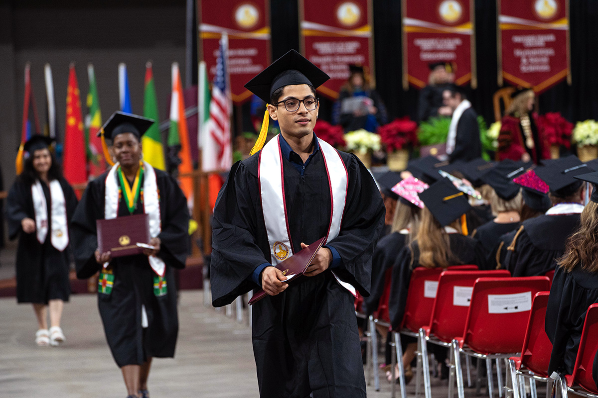 Students returning to their seats after being awarded their diplomas during the fall 2022 MSU Texas commencement ceremony.
