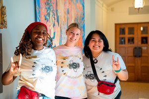 Three students with stangs up