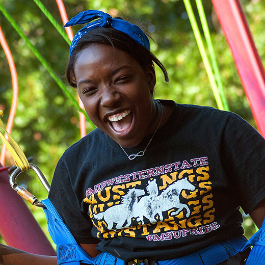A laughing student enjoys a bungee activity during Finals Frenzy.