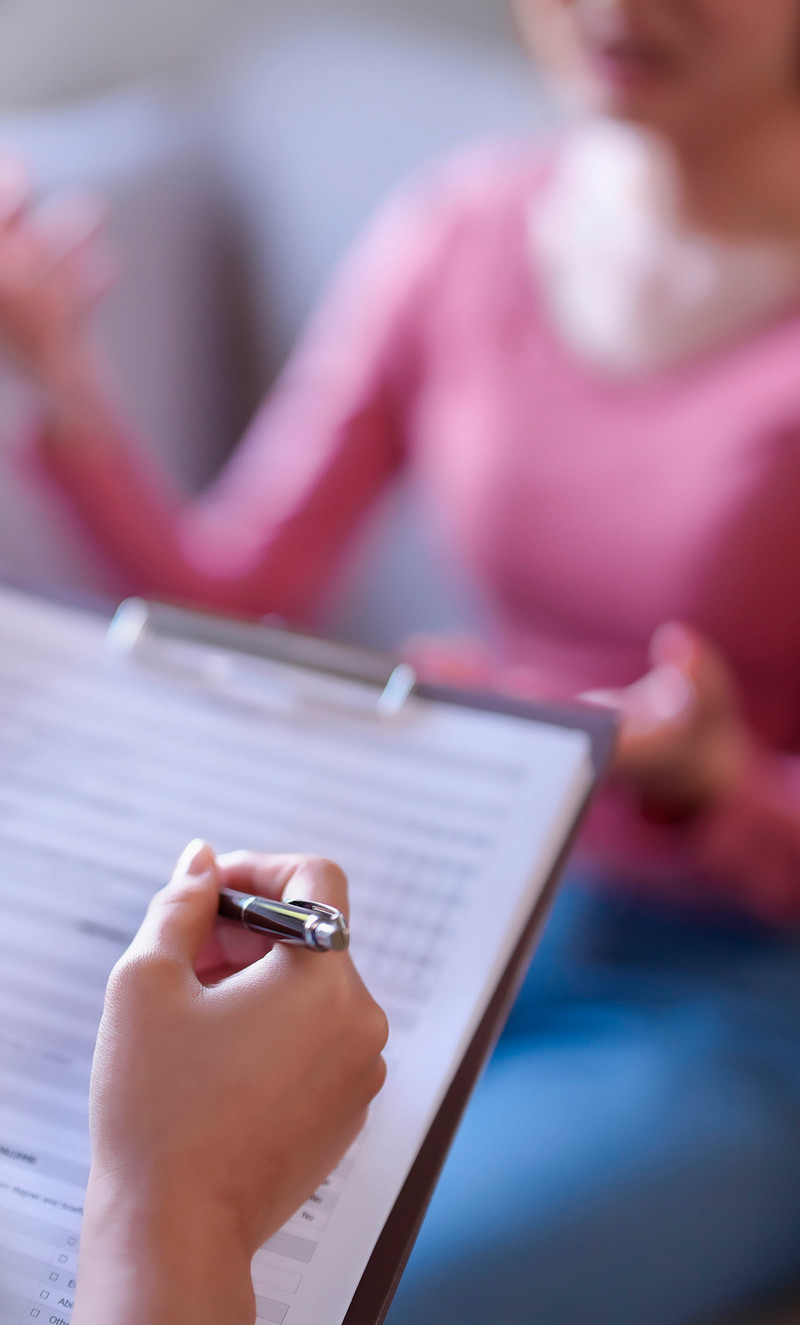 Counselor with a clipboard with a client