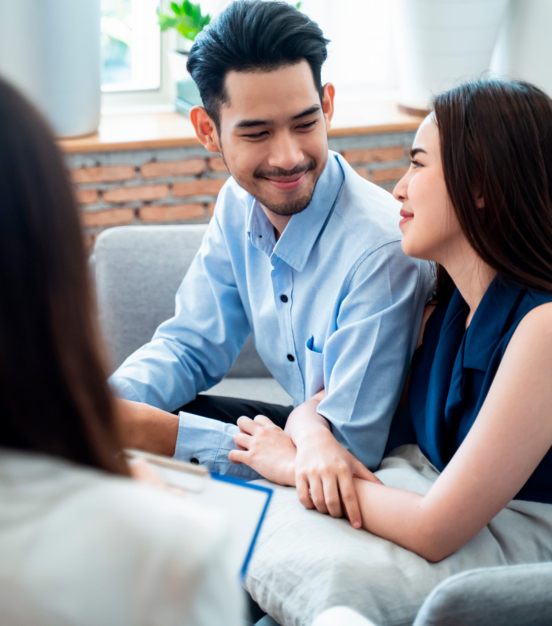 Smiling couple with a counselor