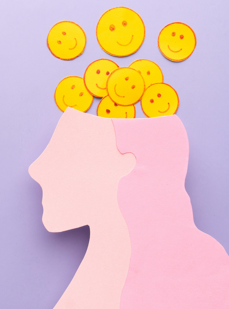 Artwork depicting smiling faces coming out of someone's head