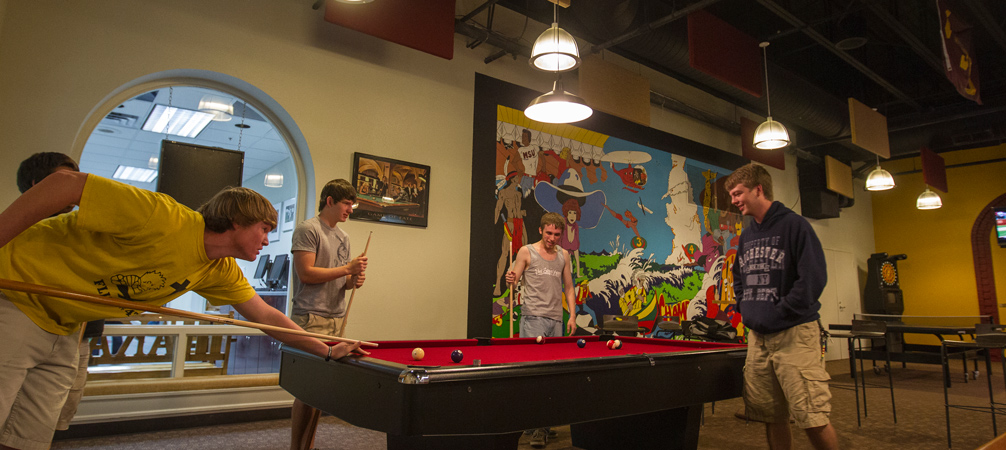Students playing pool in the recreational room