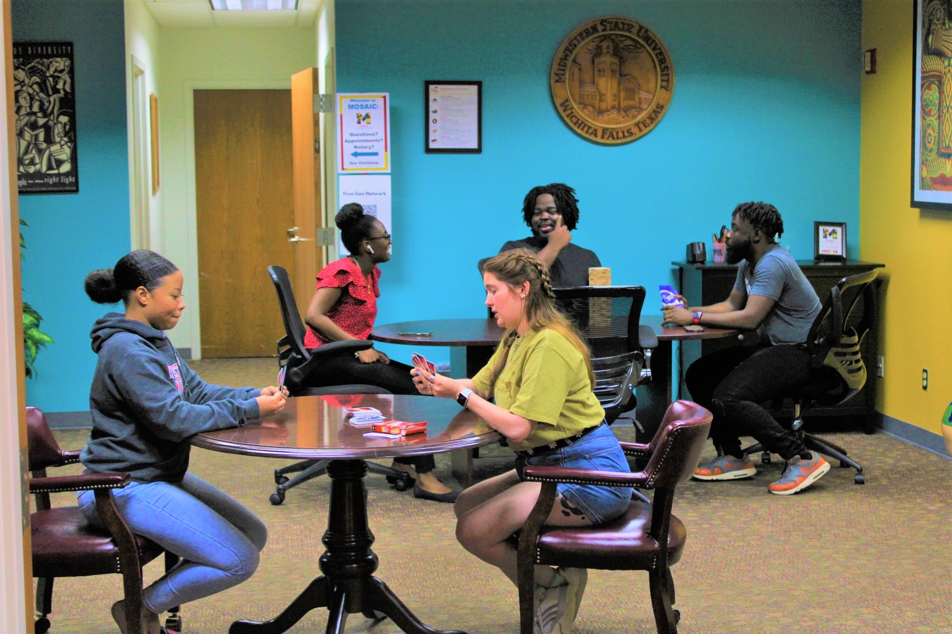 Students in the MOSAIC hub playing Jenga and Uno.