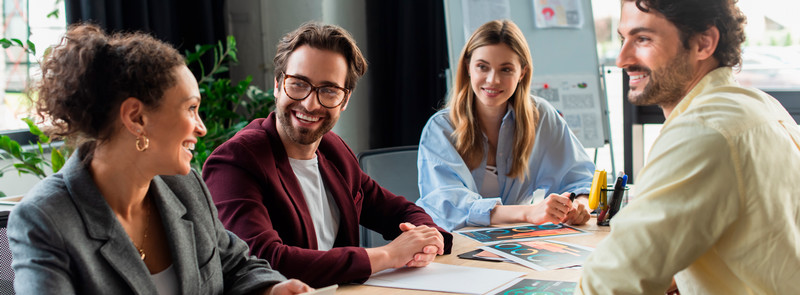 People sitting at a desk smiling