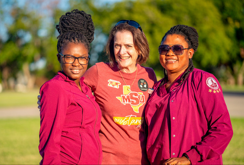 President Haynie with two students