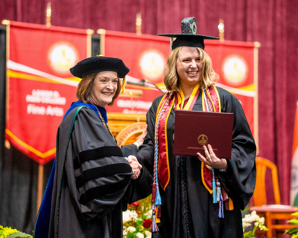 Student and President at graduation