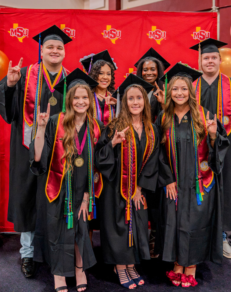 Group of student posing together after a graduation ceremony