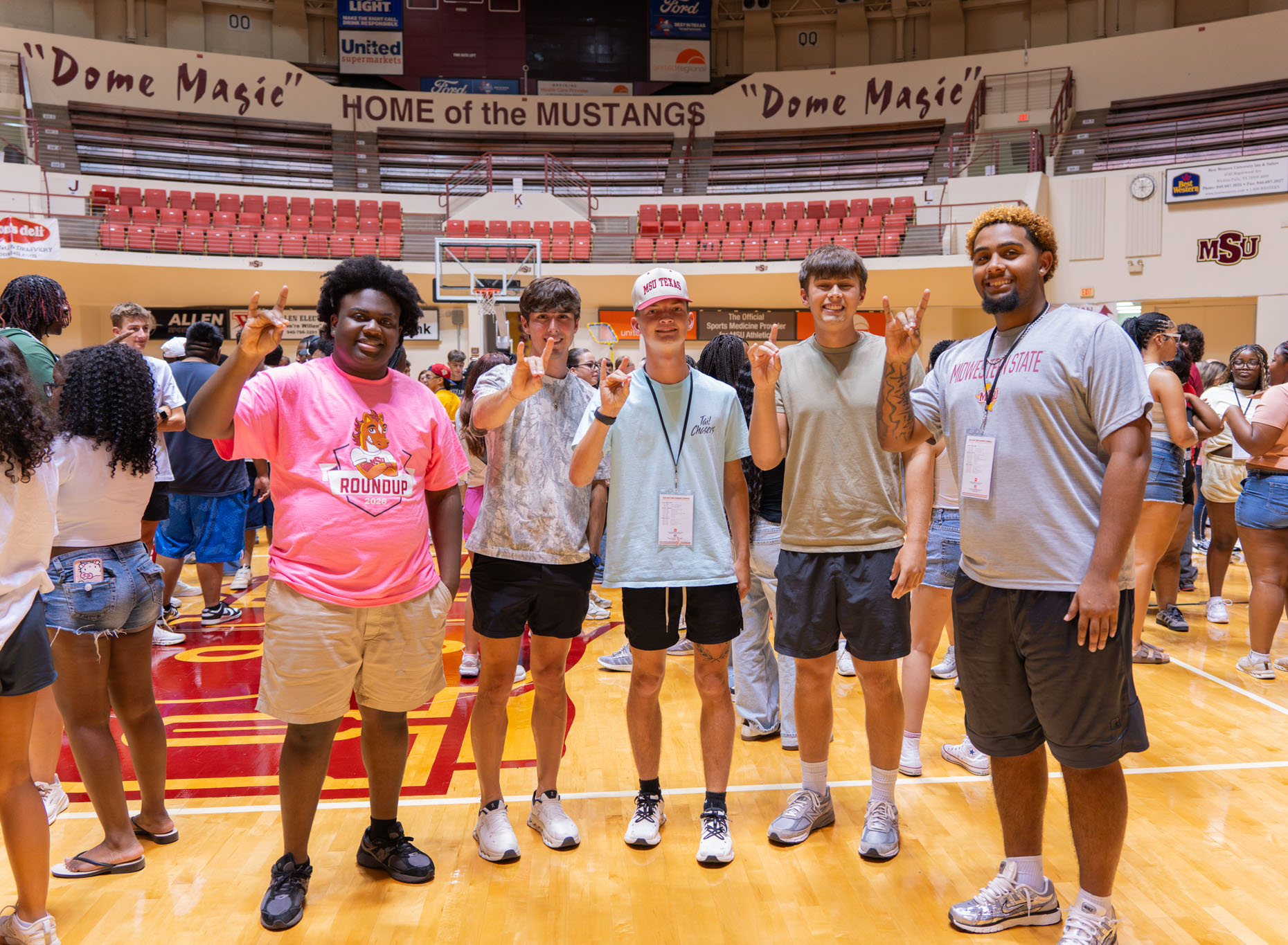 Students in DL Ligon Coliseum, stangs up