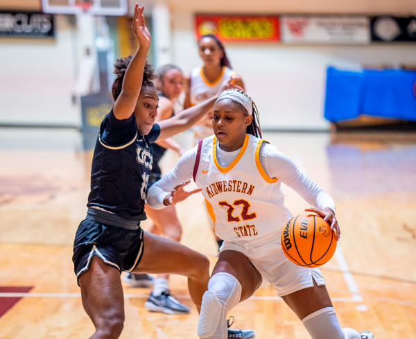 Two women playing basketball