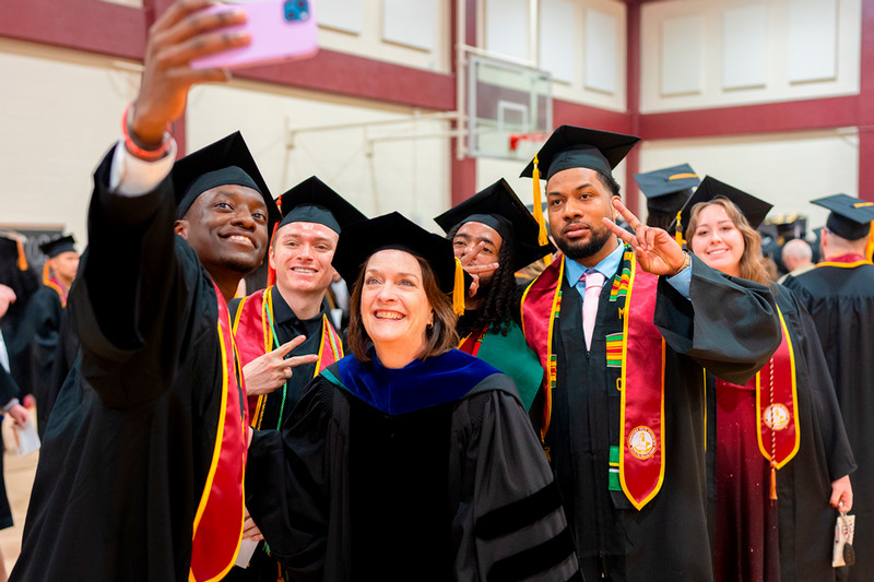 Dr. Haynie with students at graduation