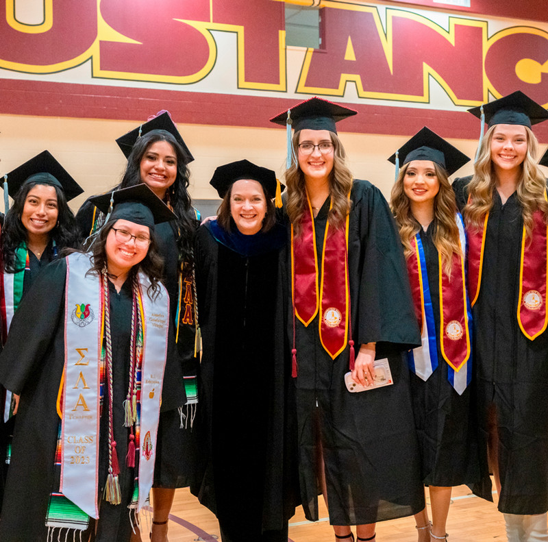 Dr. Haynie with students at graduation