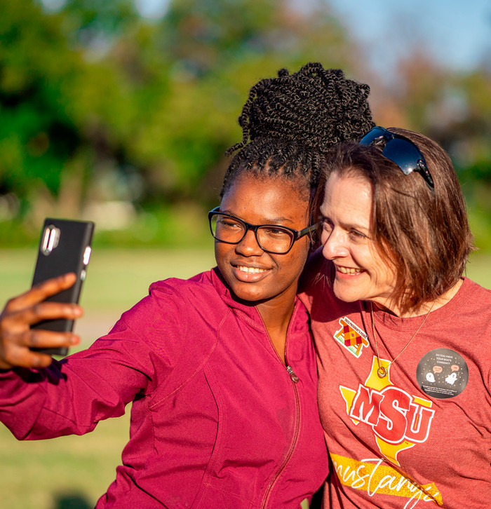 President Haynie taking a selfie with a student